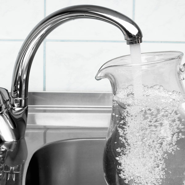 filling up water pitcher at sink